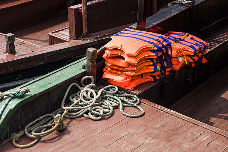 Life jackets neatly arranged on a boat for a boat rental service.